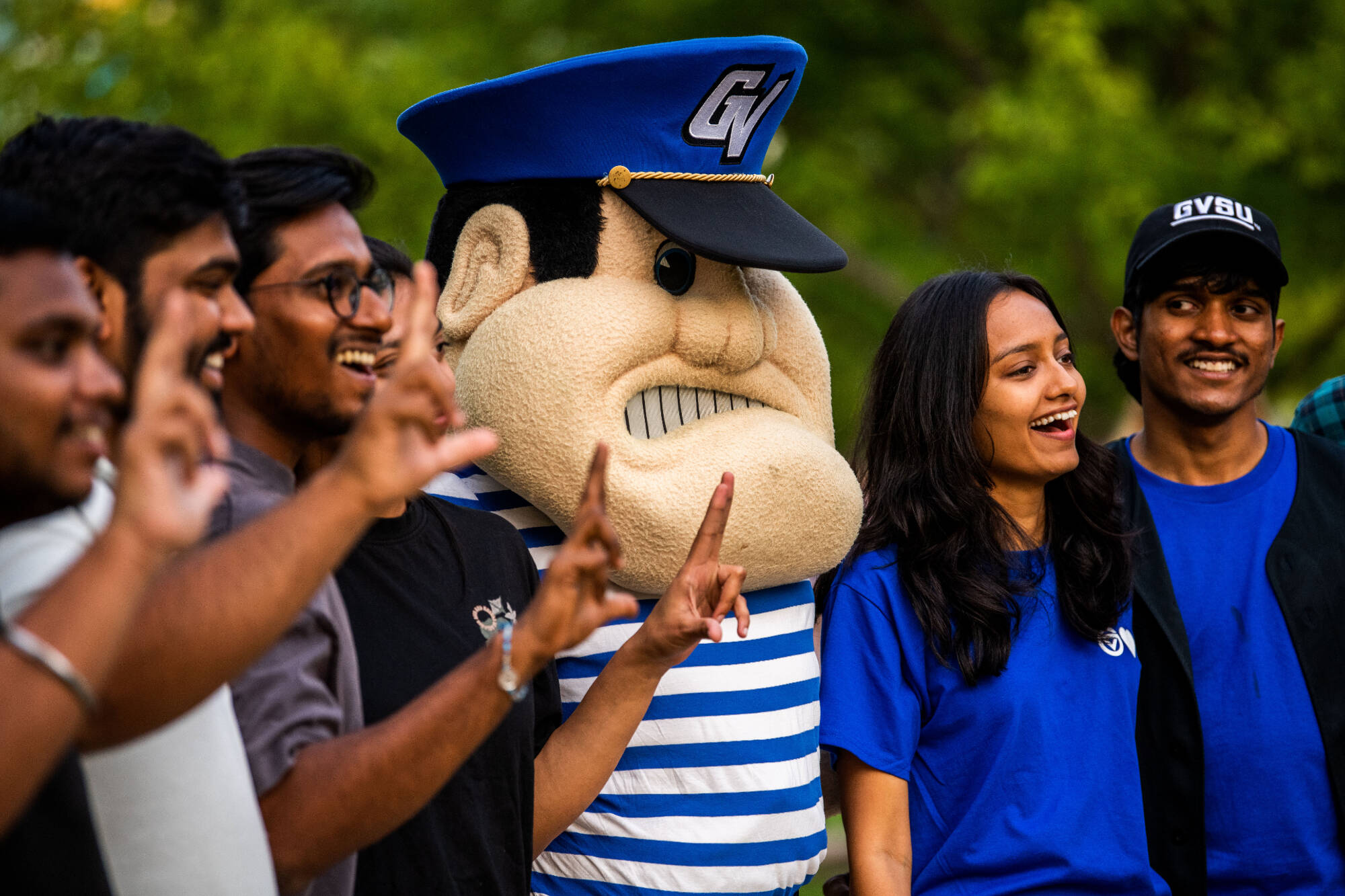 group of students standing with louie the laker. everyone's happy